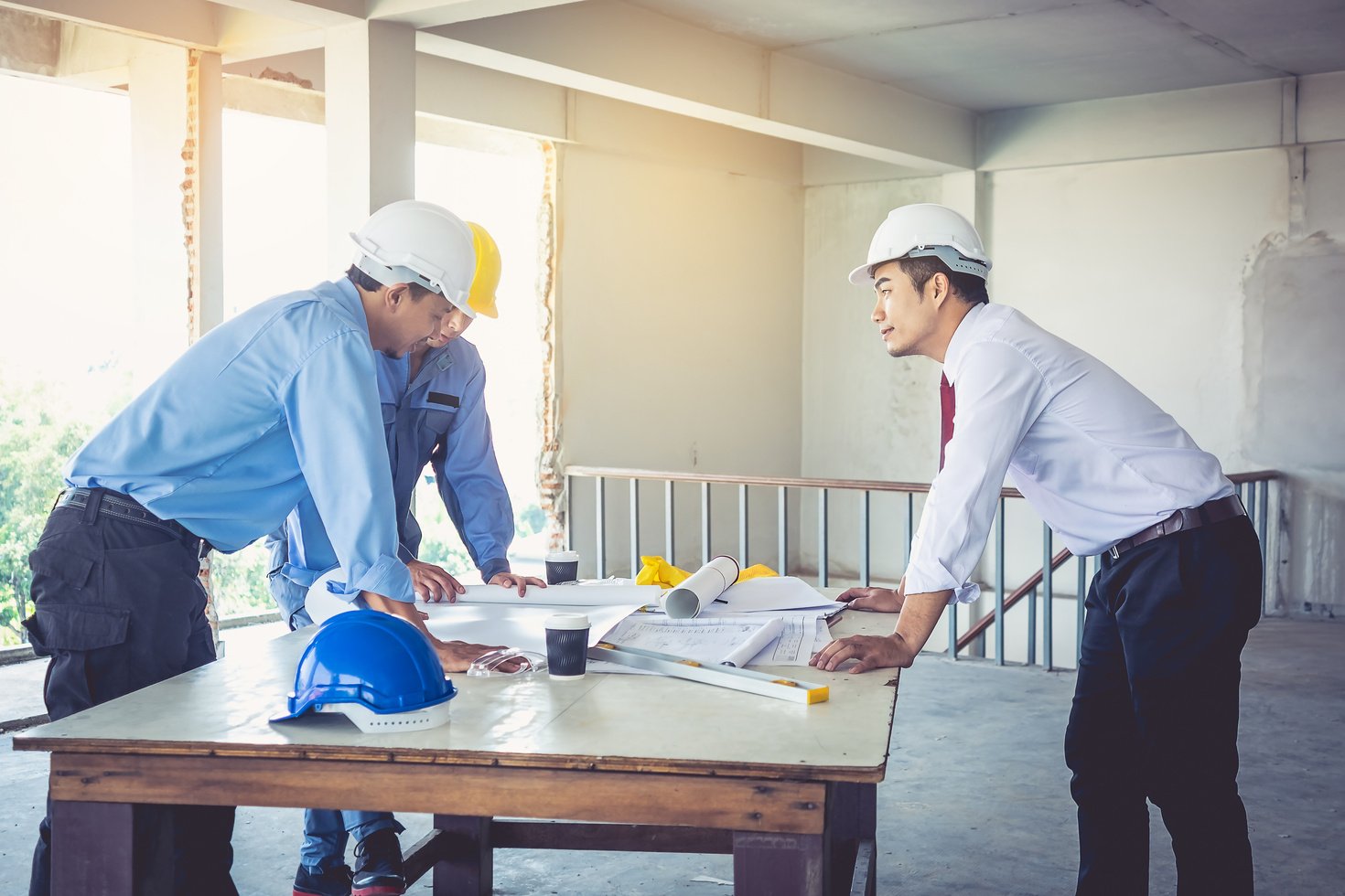 Architects, Engineers and Consultants Reviewing Blueprints